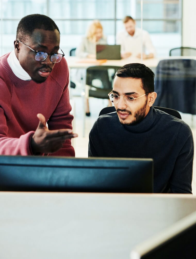 two men looking at computer