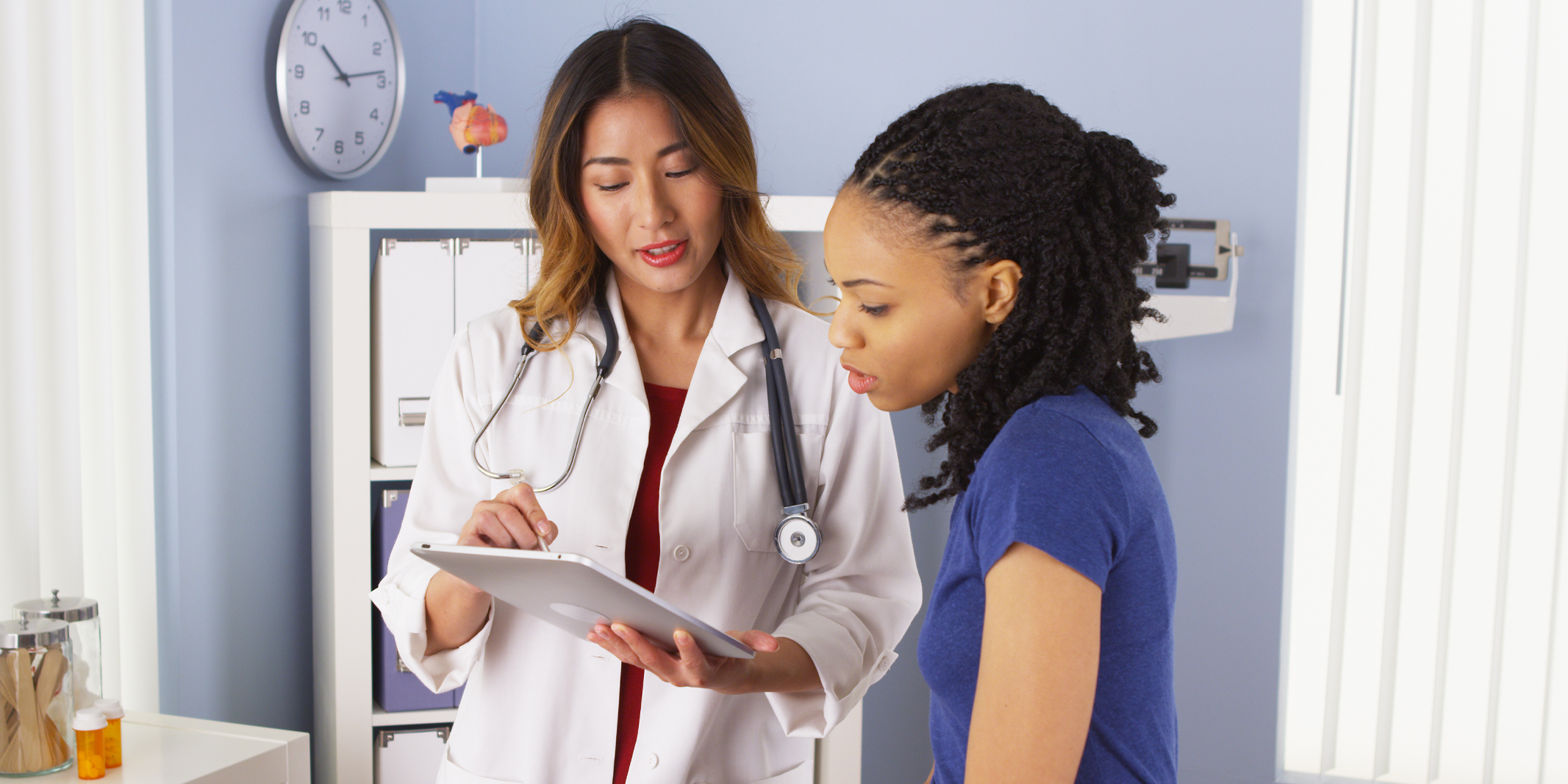 physician reviewing data with patient on tablet